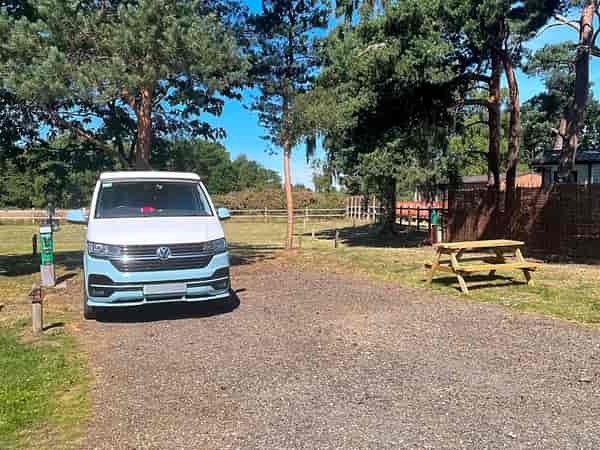 Pine views fully-serviced cement/asphalt and grass motorhome pitch