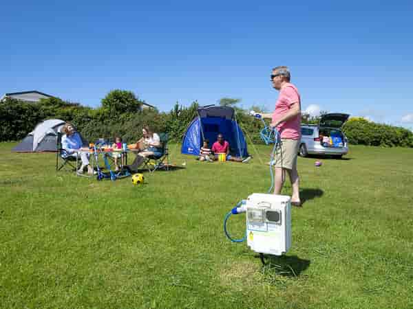 Powered grass tent or trailer tent site