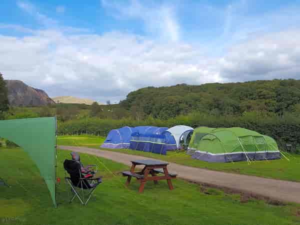 Powered grass tent site