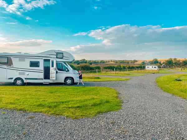Powered cement/asphalt and grass travel trailer site (2 adults and 2 children)