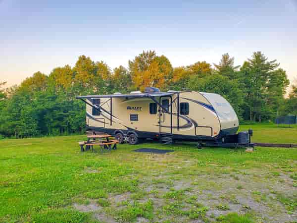 FHU cement/asphalt and grass travel trailer site (back-in)