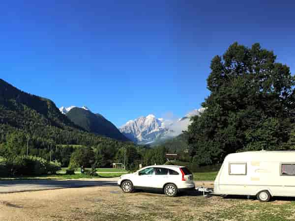 Electric optional grass and gravel touring pitch (mountain view)