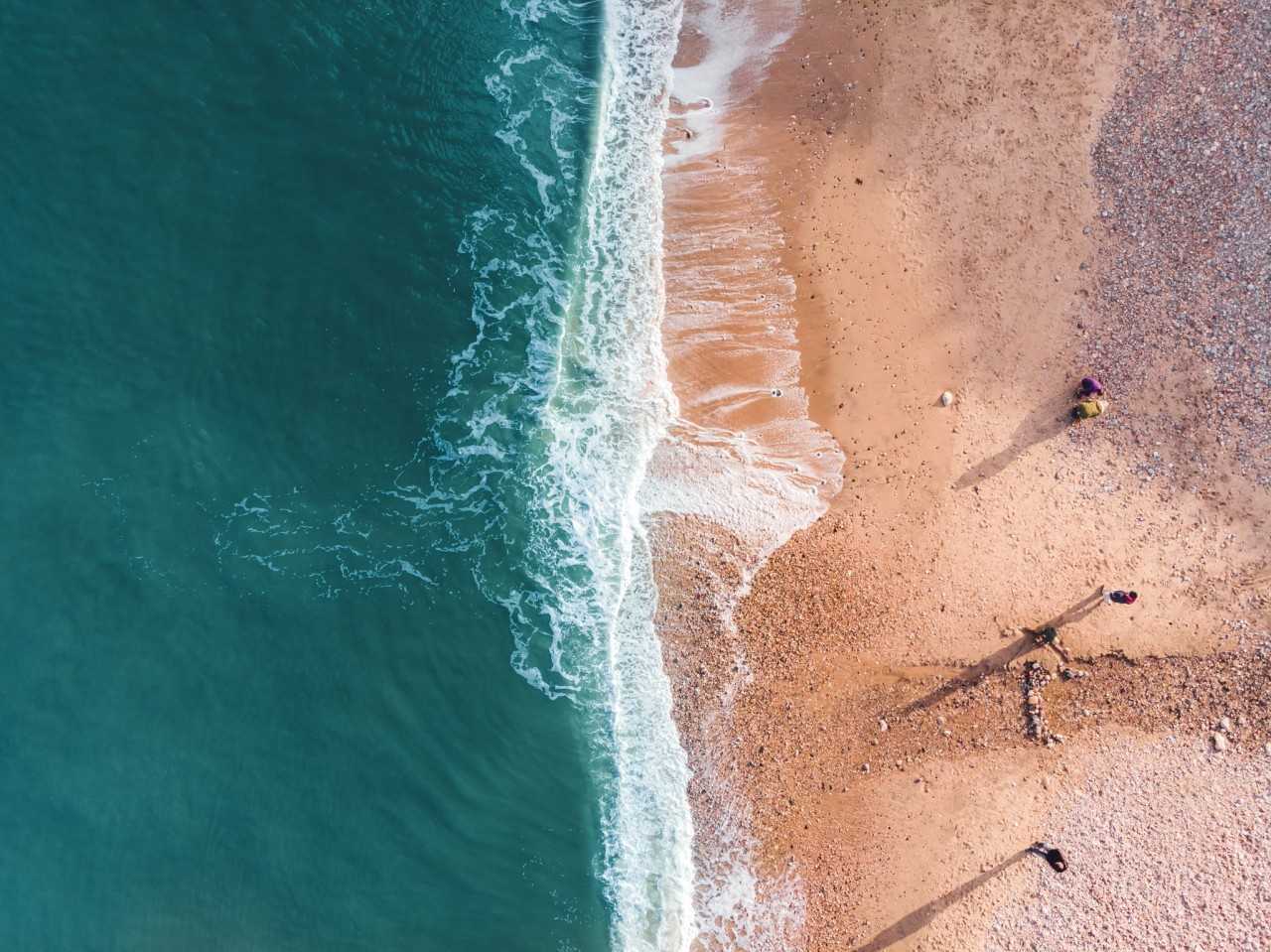 People looking for sea glass at Seaham Beach (Martin Burdon on Unsplash)