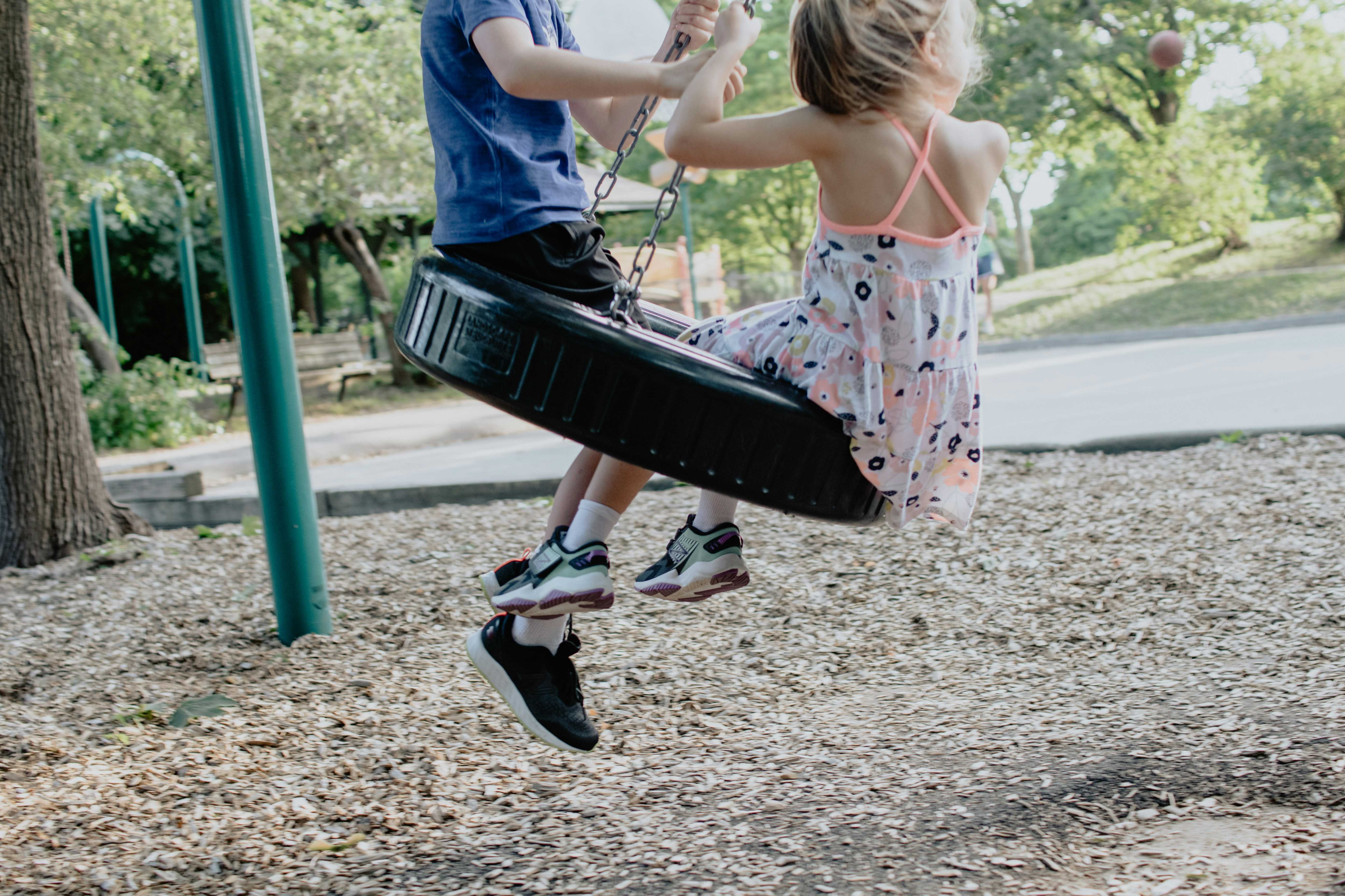 Kids being kids on a tyre swing (Kelly Sikkema/Unsplash)