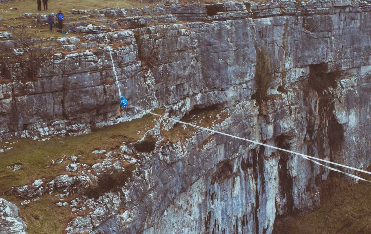 A man crossing Malham Cove on a highline (Nate Williams/Unsplash)