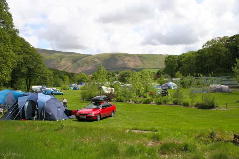 Grassy pitches with hills in the background