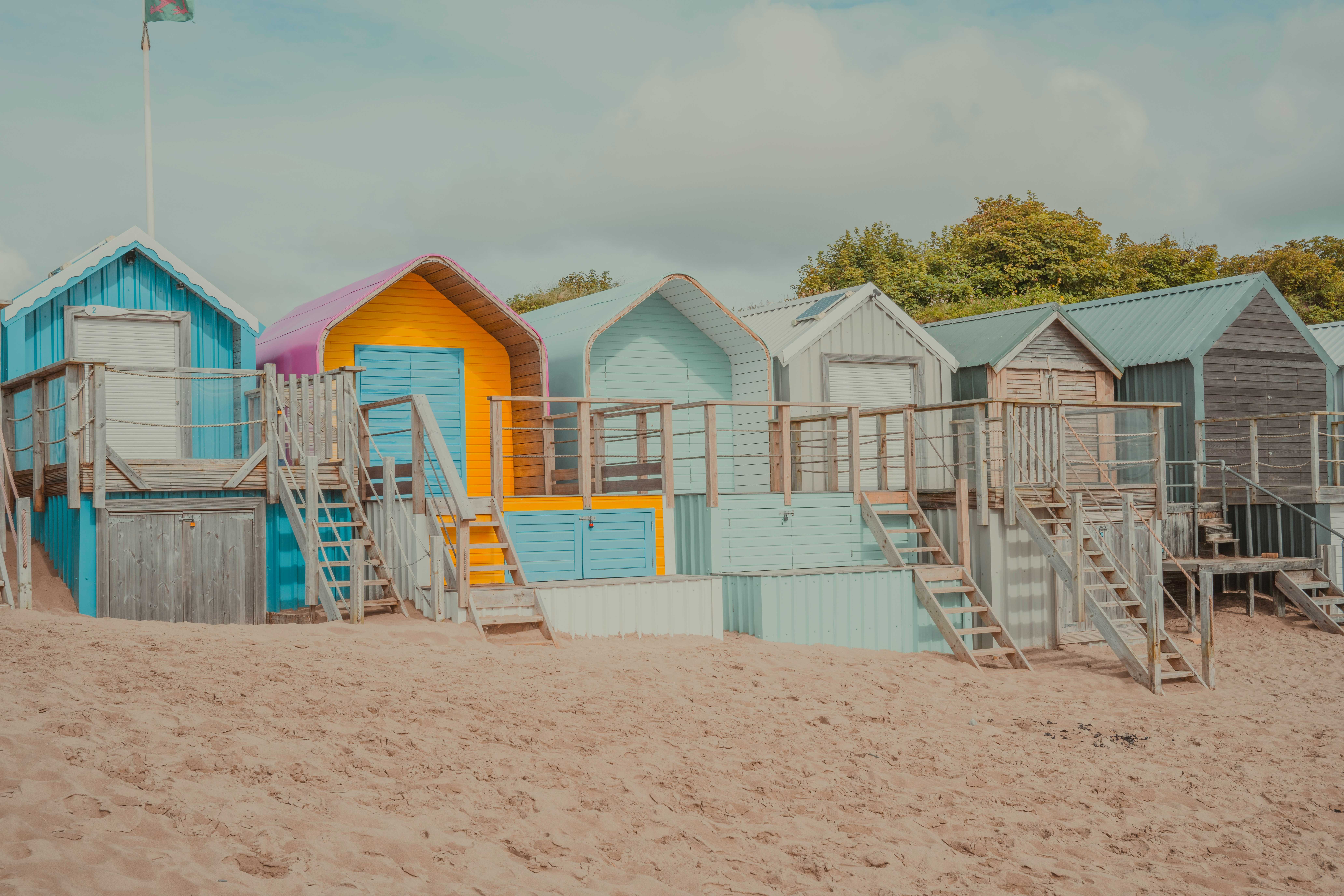 The colourful beach huts of Abersoch (Sam Carter/Unsplash)