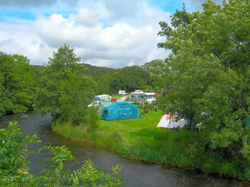 Grassy pitches alongside the riverside