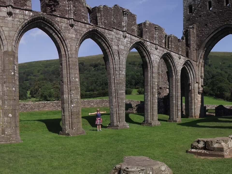 Woman standing in old ruins on a sunny day