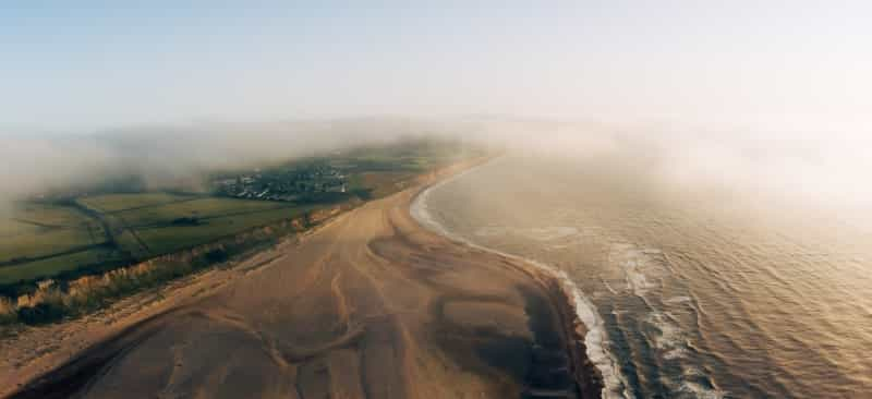 A cloudy sunrise over the beach at Kessingland (Adam Rhodes on Unsplash)