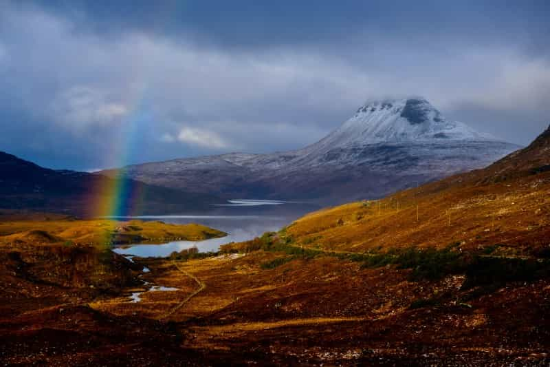 Stac Pollaidh is one of the majestic mountains you can see in the distance on the NC500 route between Gairloch and Kylesku (K B / Unsplash)