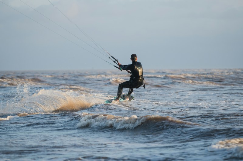 Kitesurfing is popular in Brancaster (Mark McNeill/Unsplash)