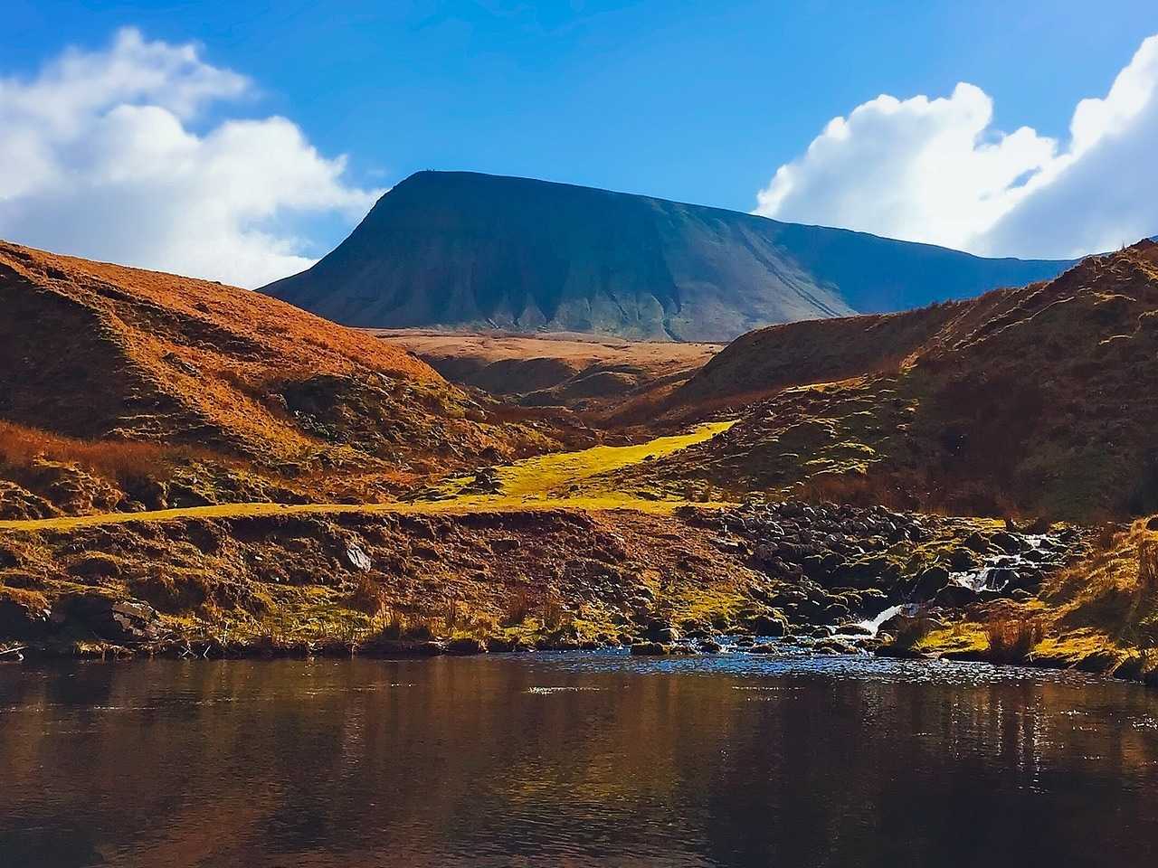 View over lake towards mountain in Brecon Beacons