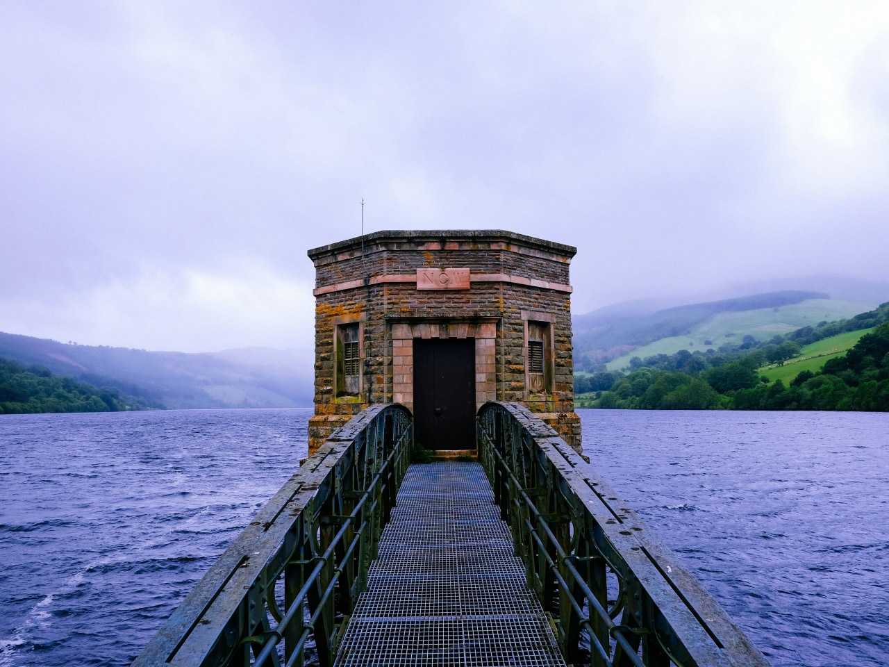 Small bridge to small building with talybont reservoir behind