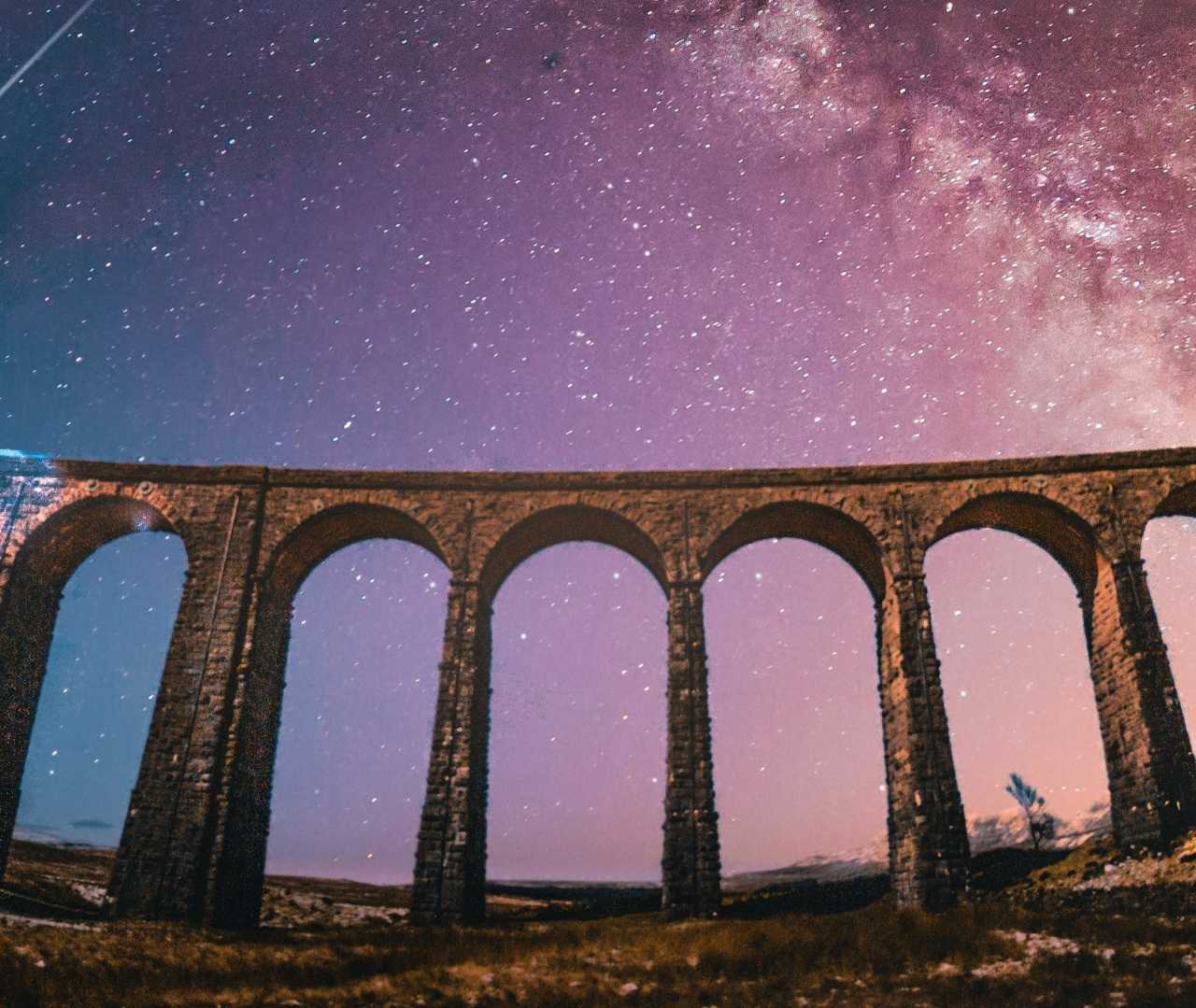 The Milky Way glittering above Ribblehead Viaduct (Jonny Gios/Unsplash)