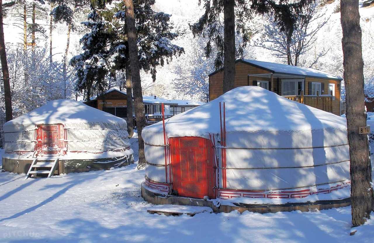 Cosy yurts under a blanket of snow
