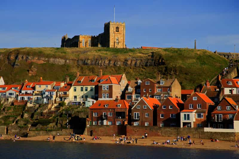 Whitby Abbey sits on a clifftop above the town of the same name (Dave Lowe/Unsplash)