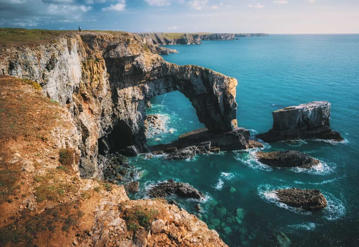 The Green Bridge of Wales is one of the highlights of the Pembrokeshire Coast Path (Ian Cylkowski / Unsplash)