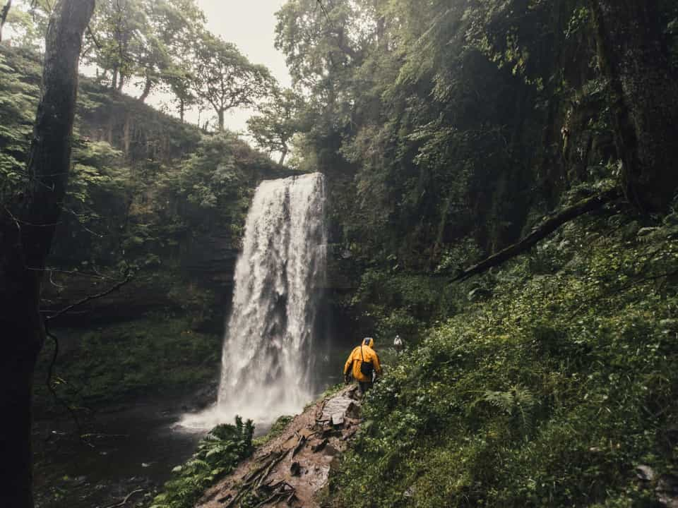 Waterfall in the rain, surrounded by lush greenery