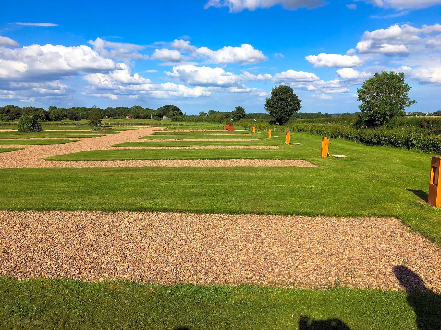  Gravel pitches surrounded by grass.