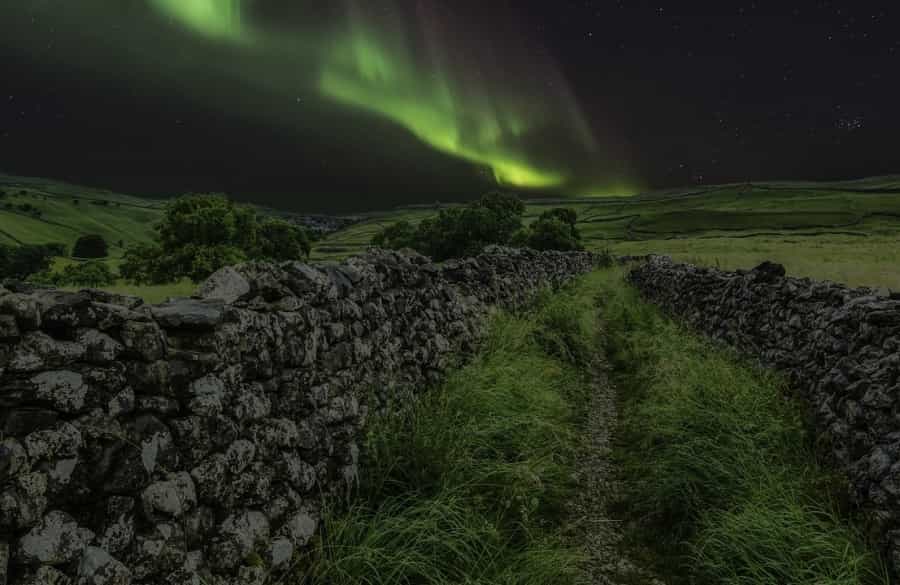 The Northern Lights dancing above dry stone walls in the Dales (Tim Hill/Pixabay)