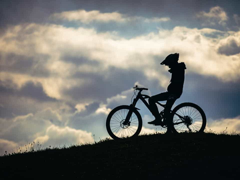 Silhouette of a mountain biker on a cloudy day