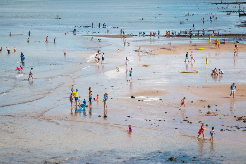 Splashing in the sea at Cromer (Anisa Mustafa/Unsplash)