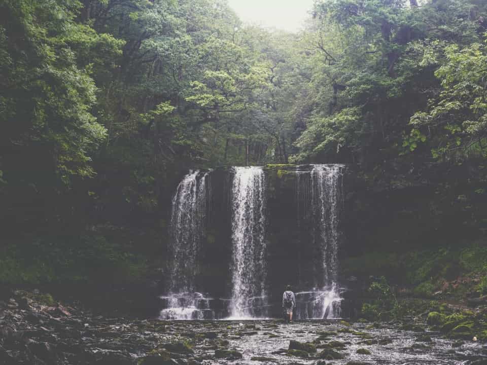 Person in front of waterfall in brecon beacons