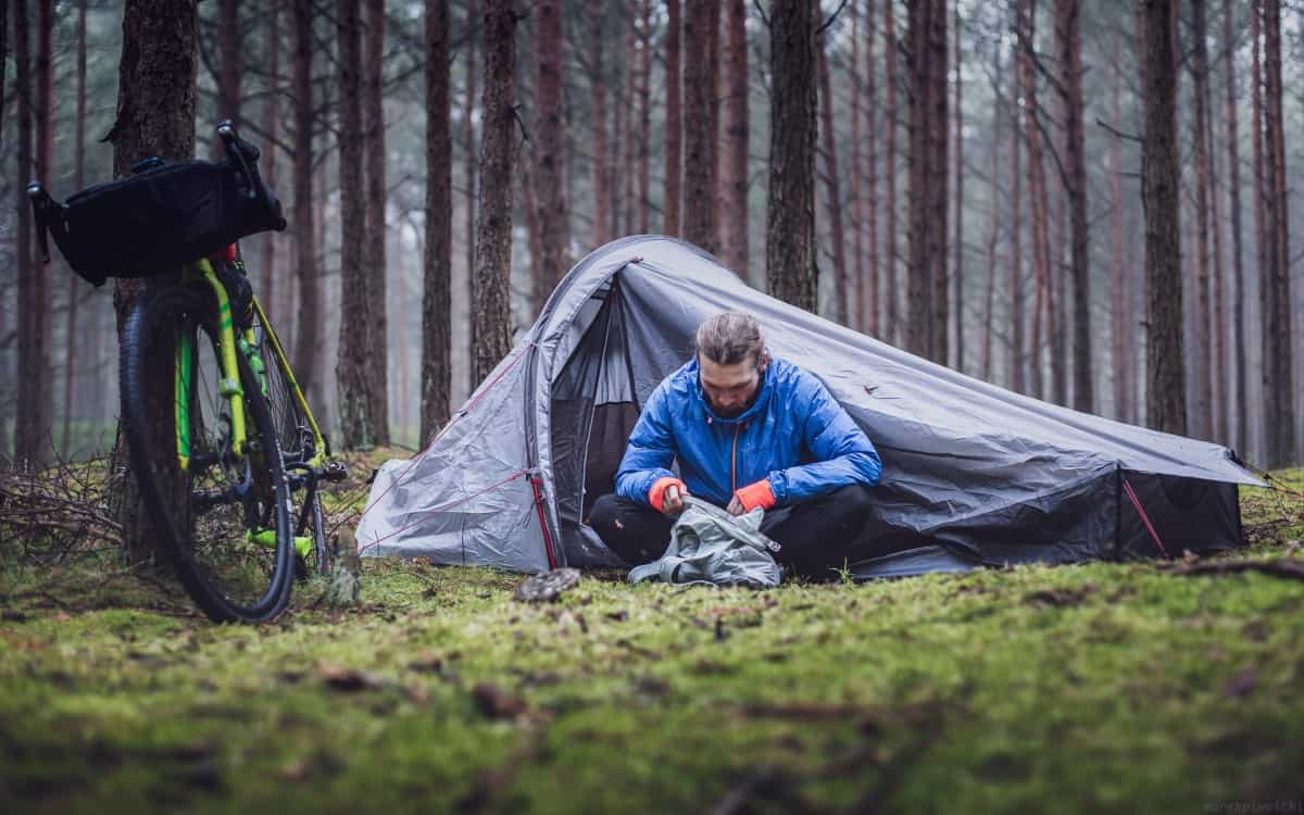 Man looking through his equipment (Marek Piwnicki / Unsplash)