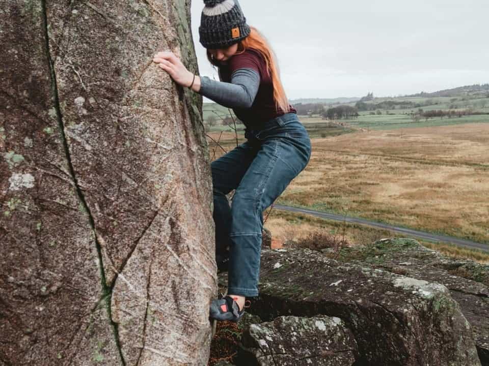 Person bouldering outside on large rock