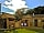 Tiny Wooden House: View from the front shows private hot tub and wooden veranda with barbecue