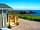 Caerfai Bay Caravan and Tent Park: Spacious lodge with spectacular views of St Brides bay, nestled at the front of Caerfai Bay