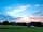 Wonders Corner Camping: Sun setting looking towards the barn where sinks, loos and showers are.