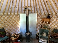 The cosy woodburning stove can be used to boil up a kettle as well as keep the yurt cosy The cosy woodburning stove can be used to boil up a kettle as well as keep the yurt cosy
