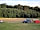 Whitlingham Broad Campsite: View from the lower field to upper field