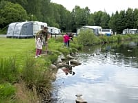 Family at the electric hardstanding touring pitch Family at the electric hardstanding touring pitch