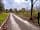 Muster Point Campsite: Access road with camping field entrance on the right and pottery studio car park ahead (photo added by manager on 24/04/2023)