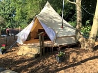 Five-metre bell tent on a wooden deck Five-metre bell tent on a wooden deck